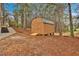 Exterior shot of a wooden storage shed with double doors and a metal roof at 12 Remington Ct, Euharlee, GA 30145