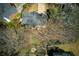 An aerial view highlights the roof, the well-manicured backyard, and the nearby homes at 210 Chiswick Close, Johns Creek, GA 30022