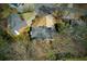 An aerial view showing the roof, the well-manicured backyard, and nearby homes at 210 Chiswick Close, Johns Creek, GA 30022