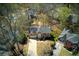 Aerial view of a brick home showcasing its manicured lawn and mature trees at 210 Chiswick Close, Johns Creek, GA 30022