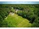 Expansive green sports field and playground in a community surrounded by lush trees at 210 Chiswick Close, Johns Creek, GA 30022