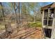 Expansive backyard with mature trees and lush greenery, visible from screened porch at 210 Chiswick Close, Johns Creek, GA 30022