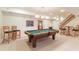 Basement game room area with a pool table, bar stools, and stairs to the main level at 210 Chiswick Close, Johns Creek, GA 30022