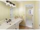 Cozy bathroom featuring a single sink vanity and adjacent water closet at 210 Chiswick Close, Johns Creek, GA 30022