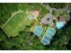 High angle shows the community amenities include tennis courts, sports fields, and swimming pool at 210 Chiswick Close, Johns Creek, GA 30022