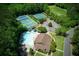 Aerial view of community amenities include the pool, tennis courts, parking, and clubhouse at 210 Chiswick Close, Johns Creek, GA 30022
