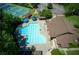 An aerial view showcases a sparkling community pool alongside tennis courts and clubhouse at 210 Chiswick Close, Johns Creek, GA 30022