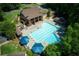 A picturesque community pool with sun loungers, umbrellas, and a nearby pavilion at 210 Chiswick Close, Johns Creek, GA 30022