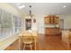 Bright dining area with hardwood floors, a skylight, a modern light fixture, and access to the back yard at 210 Chiswick Close, Johns Creek, GA 30022