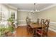 Elegant dining room features a large bay window, hardwood floors, and traditional decor at 210 Chiswick Close, Johns Creek, GA 30022