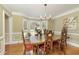 Elegant dining room features a large bay window, hardwood floors, and traditional decor at 210 Chiswick Close, Johns Creek, GA 30022