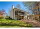 Spacious home with a large backyard, screened porch, and multi-level deck at 210 Chiswick Close, Johns Creek, GA 30022
