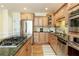 Stylish kitchen featuring stainless steel appliances, granite counters and hardwood floors at 210 Chiswick Close, Johns Creek, GA 30022