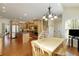 Bright kitchen with stainless appliances, granite countertops and a dining area with wooded views at 210 Chiswick Close, Johns Creek, GA 30022