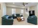 Basement living room with plush sofas, a coffee table, and a TV setup for entertainment at 210 Chiswick Close, Johns Creek, GA 30022