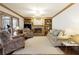 Inviting living room with a brick fireplace, built-in shelving, and access to a screened-in porch at 210 Chiswick Close, Johns Creek, GA 30022