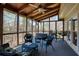 Cozy screened-in porch featuring comfortable seating and wood ceiling with fan at 210 Chiswick Close, Johns Creek, GA 30022