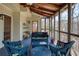 Inviting screened-in patio with comfortable seating and outdoor views at 210 Chiswick Close, Johns Creek, GA 30022