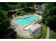 Aerial view of a community pool and clubhouse with a waterslide and sunbathing area at 210 Chiswick Close, Johns Creek, GA 30022