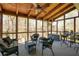 Enclosed sunroom with ceiling fan, ceiling beams and plenty of natural light at 210 Chiswick Close, Johns Creek, GA 30022