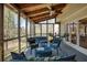 Cozy sunroom with ceiling fan, ceiling beams and beautiful wooded views at 210 Chiswick Close, Johns Creek, GA 30022