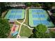 Overhead view of four tennis courts and playground in an attractive residential community at 210 Chiswick Close, Johns Creek, GA 30022
