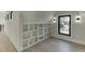 Attic room with built-in storage shelves, wood floors, and black trimmed windows at 2329 Walker Dr, Lawrenceville, GA 30043