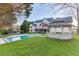 Lush backyard featuring a pool, a gazebo, a covered patio, and an expansive lawn for outdoor enjoyment at 2329 Walker Dr, Lawrenceville, GA 30043
