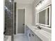 Modern bathroom with black marble tile accent wall and illuminated mirror at 2329 Walker Dr, Lawrenceville, GA 30043
