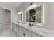 Bathroom featuring marble countertop, dual sinks, and statement mirrors at 2329 Walker Dr, Lawrenceville, GA 30043
