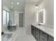 Modern bathroom featuring a glass-enclosed shower, soaking tub, double vanity, and stylish fixtures and finishes at 2329 Walker Dr, Lawrenceville, GA 30043