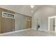 Light-filled bedroom featuring hardwood floors, vaulted ceilings, and an accent wall with modern wood panels and geometric design at 2329 Walker Dr, Lawrenceville, GA 30043