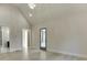 A well-lit bedroom with light hardwood floors, vaulted ceilings, and a glass door leading to an outdoor area at 2329 Walker Dr, Lawrenceville, GA 30043