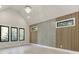 Bright bedroom with high ceilings, unique accent wall, hardwood floors, and plentiful natural light from large windows at 2329 Walker Dr, Lawrenceville, GA 30043