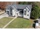 The home's facade features stone accents, a manicured lawn, modern architectural design, and an attached garage at 2329 Walker Dr, Lawrenceville, GA 30043