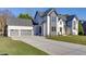 Beautiful home exterior featuring a wide driveway and a three-car garage at 2329 Walker Dr, Lawrenceville, GA 30043