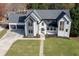 Aerial view of the exterior elevation showcasing the home's contemporary design, landscaping, and attached three-car garage at 2329 Walker Dr, Lawrenceville, GA 30043