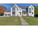 Stunning two-story home boasts a manicured lawn and modern architectural details at 2329 Walker Dr, Lawrenceville, GA 30043