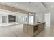 Open-concept kitchen with a large island, sleek countertops, and a view of the fireplace at 2329 Walker Dr, Lawrenceville, GA 30043