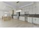 Open concept area with modern lighting, sleek cabinetry, and a view into the open kitchen at 2329 Walker Dr, Lawrenceville, GA 30043