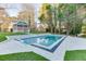 A pristine in-ground swimming pool with a tiled deck, a gazebo, and mature trees creating a serene outdoor oasis at 2329 Walker Dr, Lawrenceville, GA 30043