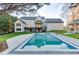 A large, inviting pool is set against the home's backyard with a covered patio at 2329 Walker Dr, Lawrenceville, GA 30043