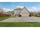 Back exterior showcasing a fenced in yard with lawn, patio and attached two car garage at 1527 Sage Ridge Dr, Marietta, GA 30064