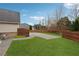Picture of a grassy backyard with wood fence and concrete patio, bordered with trees at 1527 Sage Ridge Dr, Marietta, GA 30064