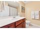 Bright bathroom features a white countertop, cherry wood vanity, and well-lit mirror at 1527 Sage Ridge Dr, Marietta, GA 30064