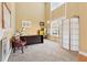 Home office with high ceilings, carpeted floor, large window, and adjacent to living area at 1527 Sage Ridge Dr, Marietta, GA 30064