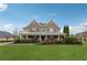 Charming brick home with a well-manicured lawn, mature trees, and inviting front porch at 1527 Sage Ridge Dr, Marietta, GA 30064
