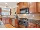 Updated kitchen featuring stainless steel appliances, wooden cabinets and granite countertops at 1527 Sage Ridge Dr, Marietta, GA 30064