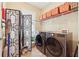 Laundry room featuring a large washer and dryer, storage shelves, and decor at 1527 Sage Ridge Dr, Marietta, GA 30064