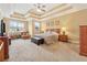 Main bedroom featuring tray ceiling, carpeted floor, ceiling fan, and ensuite bathroom at 1527 Sage Ridge Dr, Marietta, GA 30064